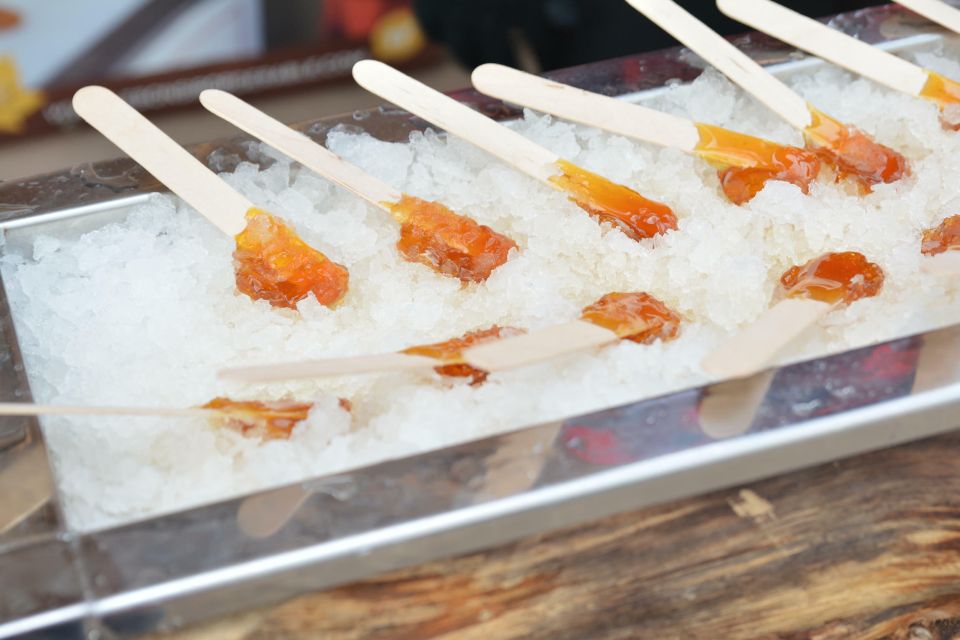 maple syrup rolled up by popisicles sticks on top of ice 